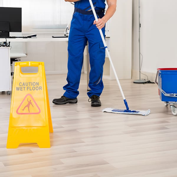 Mopping-floor-w-caution-sign - Miller & Sons